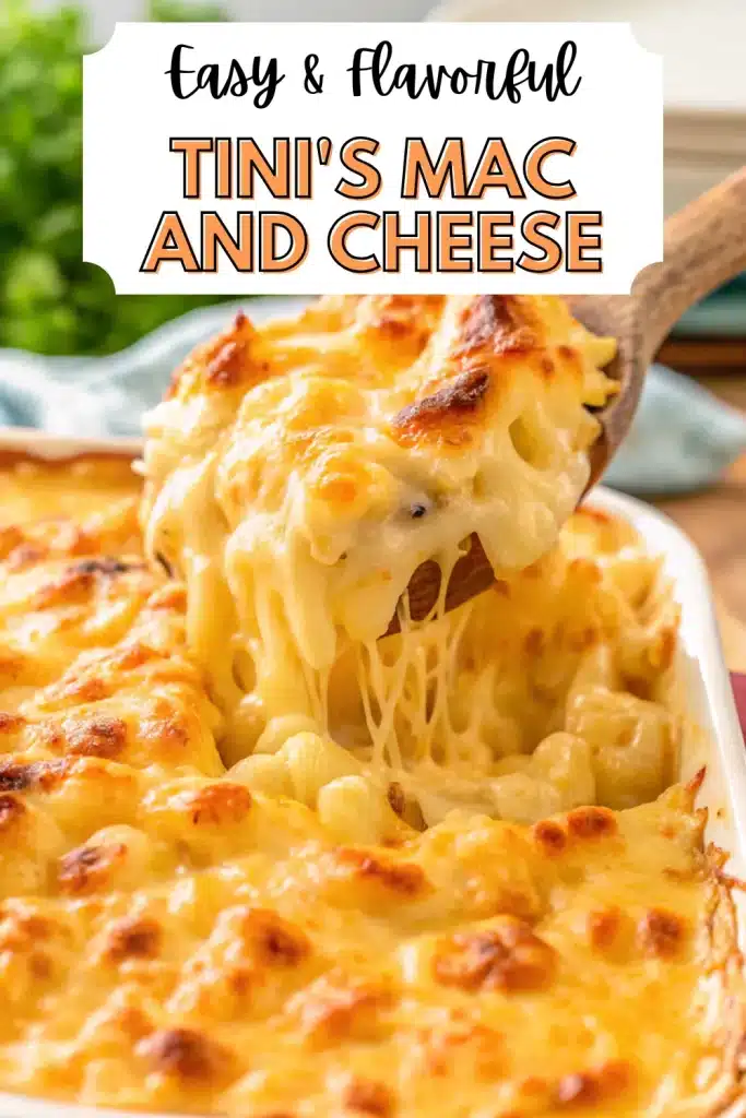 A close-up of Tini's Mac and Cheese, showing creamy cheese sauce and golden baked cavatappi pasta in a white baking dish